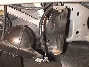 Removing bumper bracket bolts.