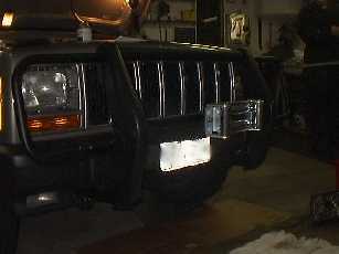 Bolt the roller fairlead onto the grille guard.