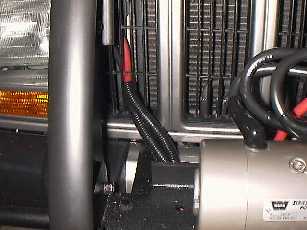 Mount the power cables through the grille.
